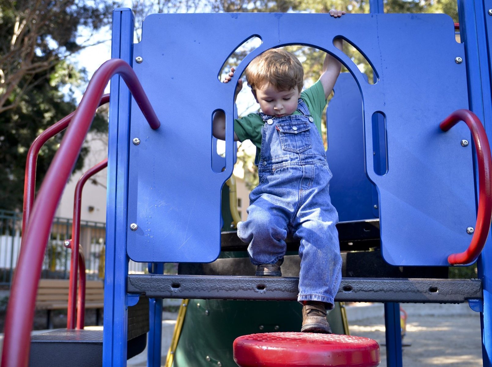 toddler on playground structure