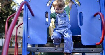 toddler on playground structure