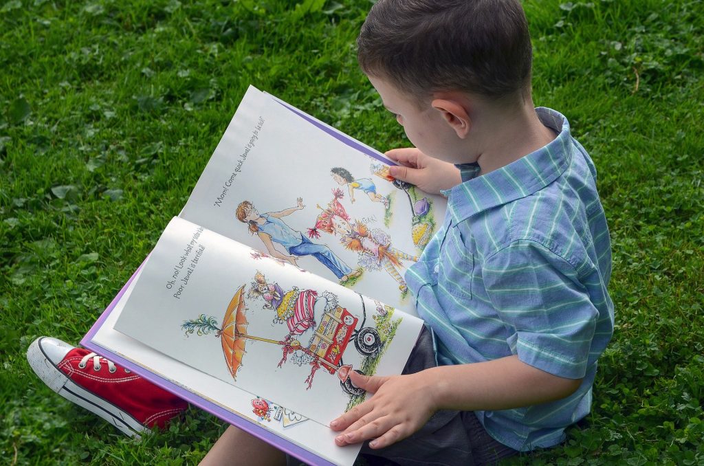 young boy reading a book